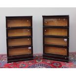 A pair of mahogany four section bookcases with a moulded top and base,