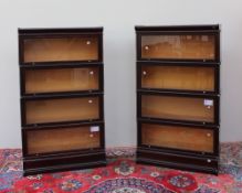 A pair of mahogany four section bookcases with a moulded top and base,