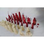 A 19th century Chinese carved ivory chess set, natural and stained red,
