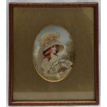 A painted silk and woolwork miniature depicting a young lady holding a fan,