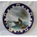 A Royal Worcester porcelain plate painted to the centre with fishing boats coming into shore on a