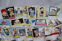 A collection of circa 25 Mabel Lucie Attwell postcards together with a collection of comic,