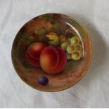 A Royal Worcester porcelain pin tray of circular form painted with peaches and grapes to an ivory