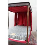 An 18th century oak four poster bed, with a moulded cornice above a shallow frieze,