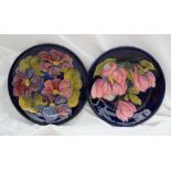 Two Moorcroft pottery plates, one decorated in the magnolia pattern, 25.