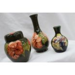 A Moorcroft pottery ginger jar and cover decorated in the hibiscus pattern to a green ground,