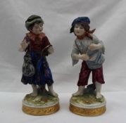 A pair of late 19th century German porcelain figures of a young peasant boy and girl,