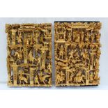 A pair of carved Oriental panels depicting figures on horseback amongst trees and buildings 42cm