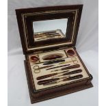 An early 20th century leather travelling manicure set, enclosing a mirror and scissors, nail pad,