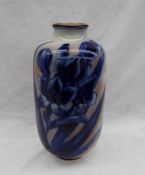 A Royal Doulton pottery vase, decorated with flower heads and leaves in blue and white,