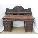 An Anglo Indian carved hardwood desk, decorated with figures, flowers and leaves,