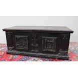 A large 19th century carved oak coffer the rectangular top with a geometric carved edge,