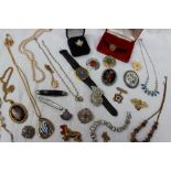A collection of costume jewellery including a wristwatch, faux pearls, brooches,