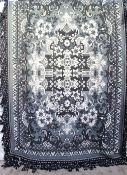 A large black and white wool bed spread,