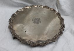 A late Victorian silver salver with a shaped edge the plate engraved with a coat of arms "Honor