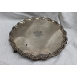 A late Victorian silver salver with a shaped edge the plate engraved with a coat of arms "Honor