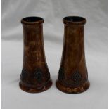 A pair of Royal Doulton vases with circular bases, tapering bodies, and small circular rims,