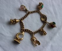 9ct yellow gold charm bracelet, set with numerous charms including a matador, toby jug, lanterns,