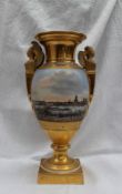 A continental porcelain twin handled vase, with a gilt flared rim, with winged terminal handles,