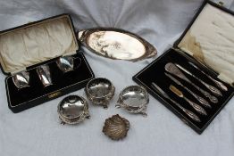 A pair of Victorian silver cauldron table salts, embossed with flowerheads and leaves on hoof feet,