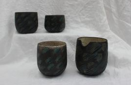 Studio pottery by Barbara Ineson - A pottery vase with a black ground decorated in blues and greens,