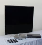 A Bang & Olufsen Beovision 11-40 all black flat screen television, with motorised floor stand,