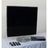 A Bang & Olufsen Beovision 11-40 all black flat screen television, with motorised floor stand,