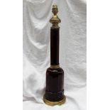 A ruby glass and brass table lamp, with a brass ogee shaped top above a octagonal column,