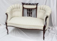 An Edwardian mahogany two seater settee,