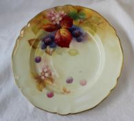 A Royal Worcester porcelain plate painted with blackberries and leaves to an ivory ground,