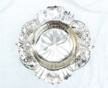 An electroplated WMF dish of lobed circular form with a leaf and fruit pierced border, on ball feet,