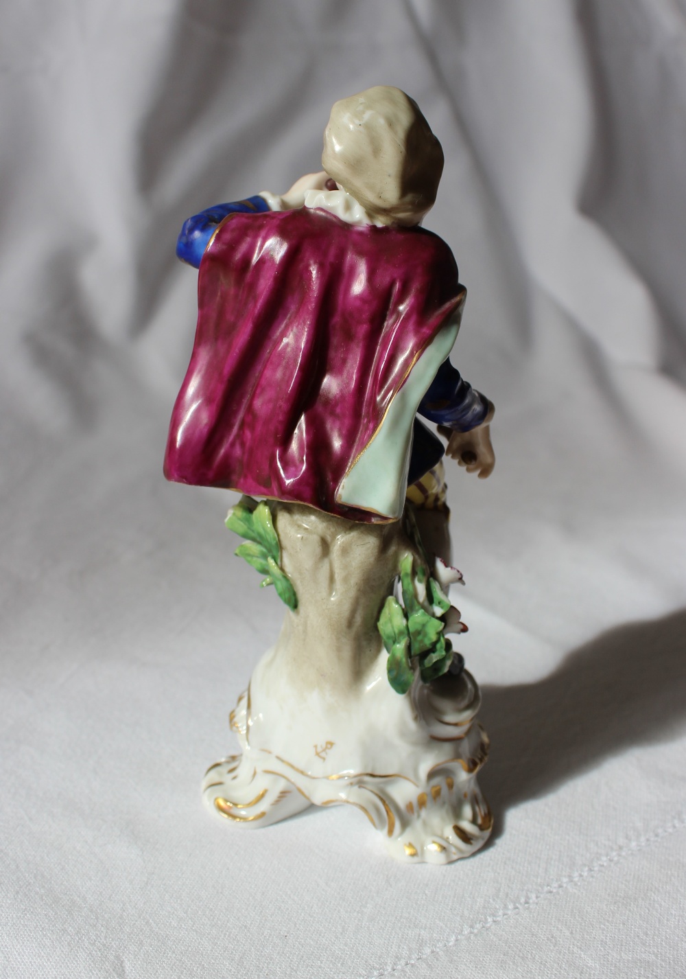 A 19th century porcelain seated figure, with a drum on his hip, in a gilt decorated blue tunic, - Image 4 of 5