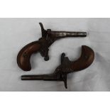 Two 19th century 'Bicycle' Muff pistols, with wooden grips,