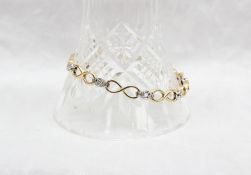 An 18ct yellow and white gold diamond set tennis bracelet,