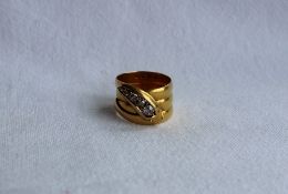 An 18ct yellow gold ring in the shape of a serpent, the head set with graduated old cut diamonds,