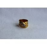 An 18ct yellow gold ring in the shape of a serpent, the head set with graduated old cut diamonds,