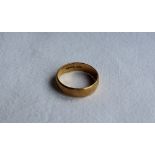 A 22ct gold wedding band, size T, approximately 6.