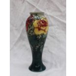 A Moorcroft limited edition pottery vase decorated in the rose pattern to a graded green ground,