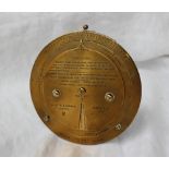 A Negretti and Zambra desk top brass barometer dial with a fixed outer rim for Barometer readings,