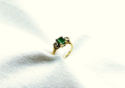 An emerald and diamond ring, the rectangular emerald approximately 7mm x 6mm,