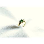 An emerald and diamond ring, the rectangular emerald approximately 7mm x 6mm,