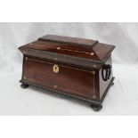 A Victorian rosewood sarcophagus shaped tea caddy, with a quarter reel moulded border,