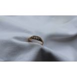A five stone diamond ring set with graduated round old cut diamonds to an 18ct yellow gold setting