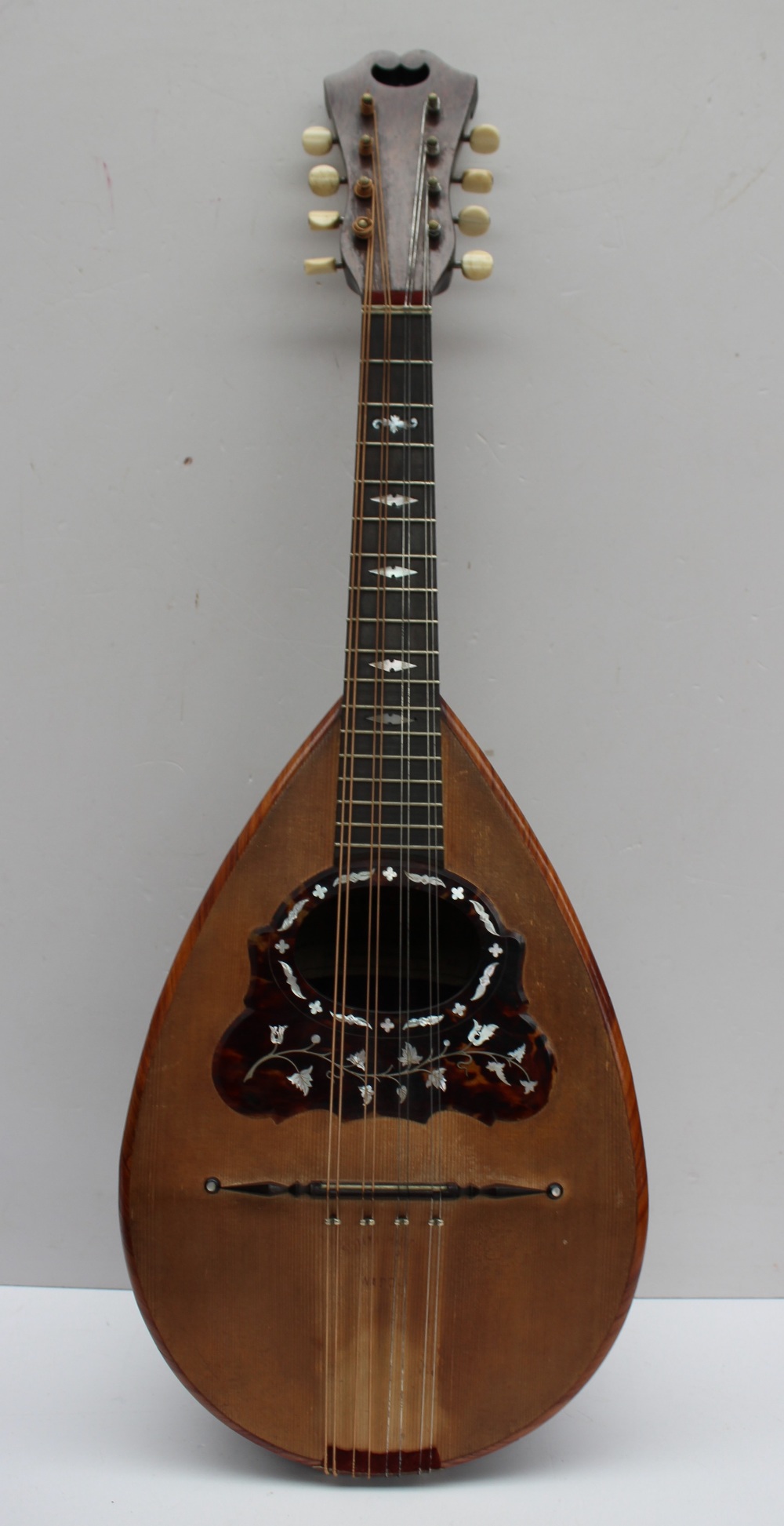 An Umberto Ceccherini bowl back mandolin, bears a trade label dated 1881,