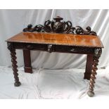 A 19th century carved oak low countries side table the raised back carved with a head and scrolls,