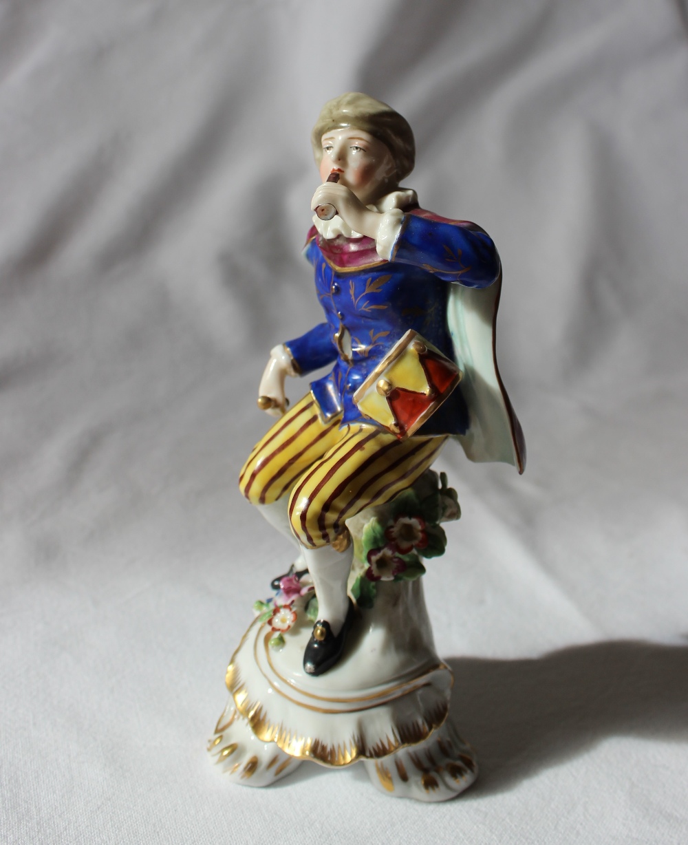 A 19th century porcelain seated figure, with a drum on his hip, in a gilt decorated blue tunic, - Image 2 of 5