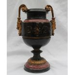 A late 19th century black slate and variegated red marble urn with scrolling gilt mask handles,