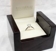 A solitaire Moissanite ring,