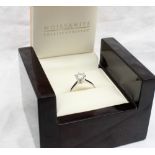 A solitaire Moissanite ring,