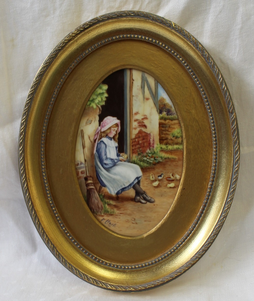 A Francis Clark porcelain plaque of oval form painted with a young girl feeding chicks,